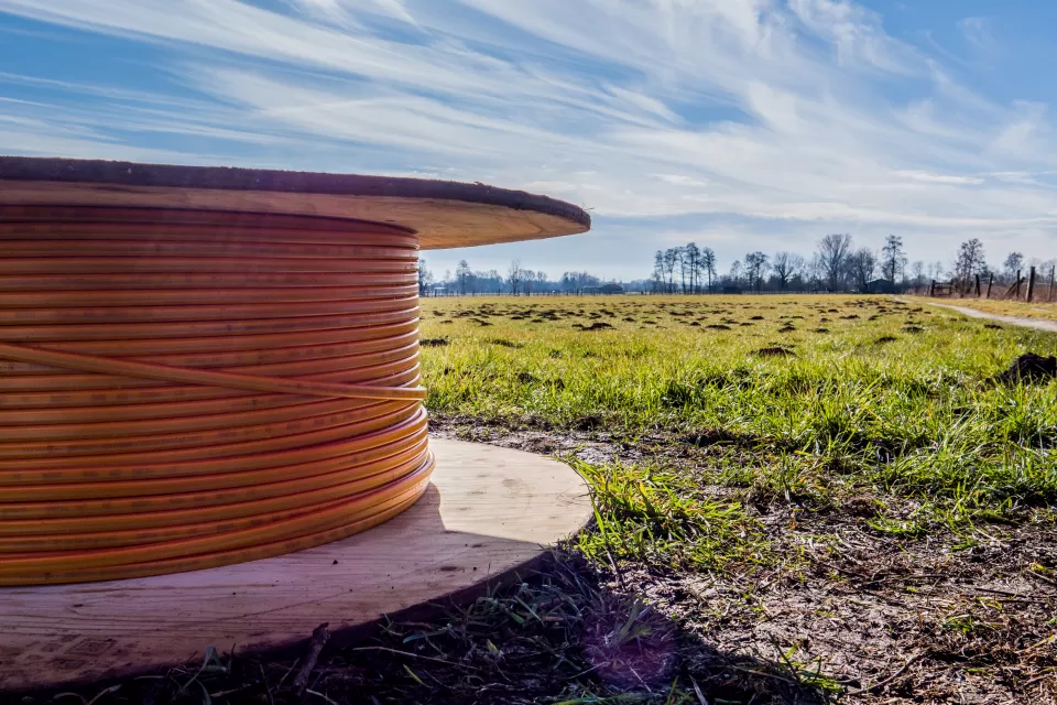 Close-up of spool of broadband internet wire sitting on the ground